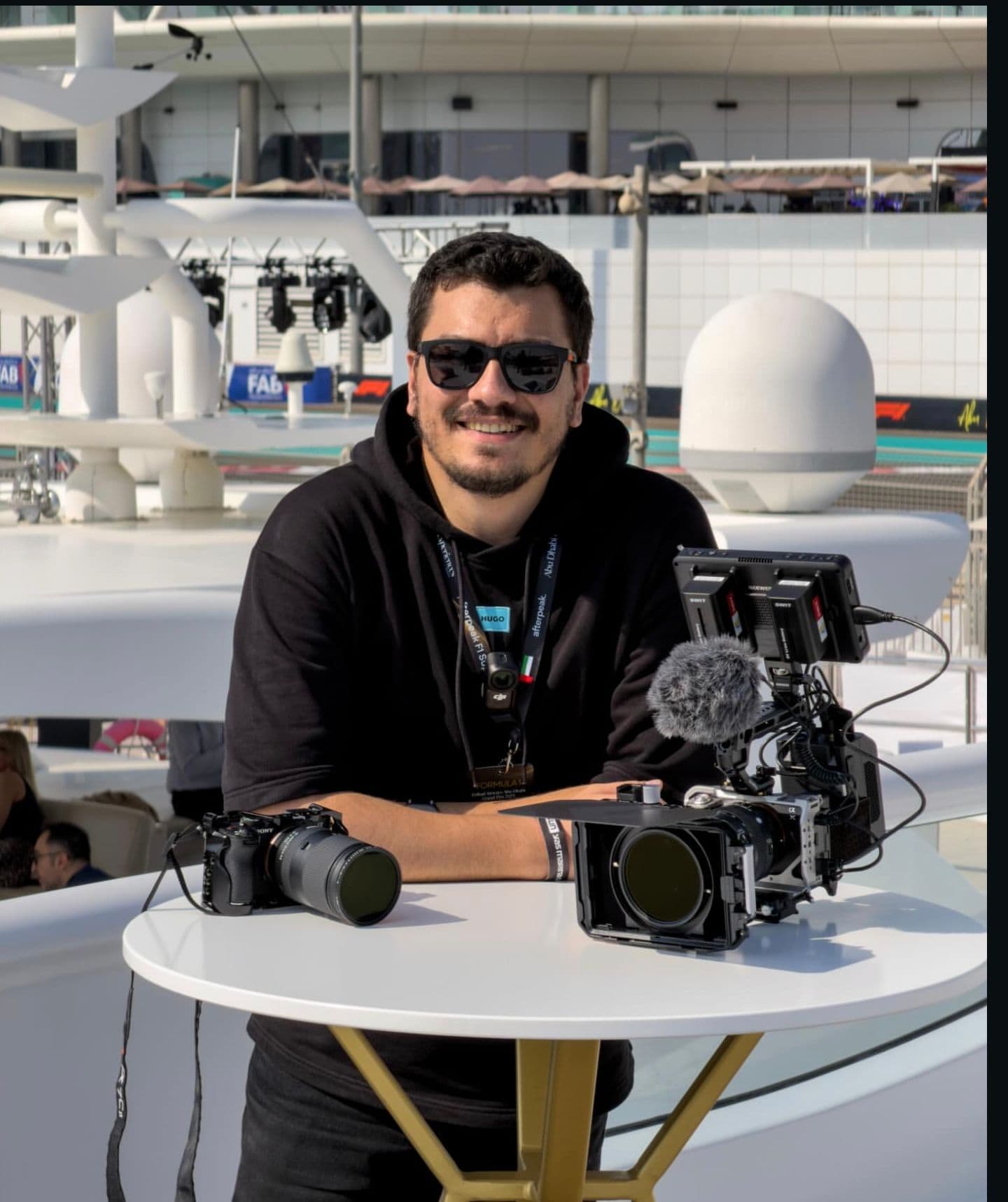 Ali Kanaan — founder of Tuned In Motion, with camera rig at the track